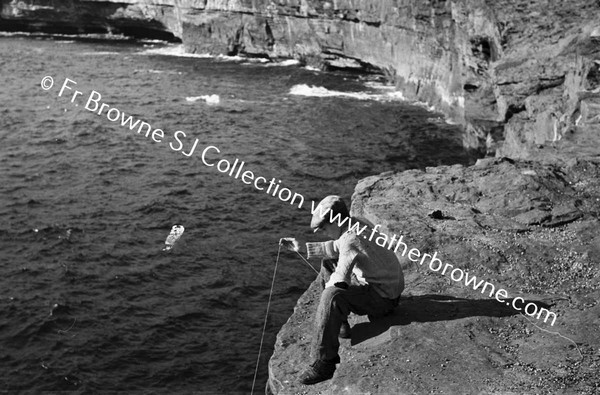 BOY FISHING FROM CLIFFS